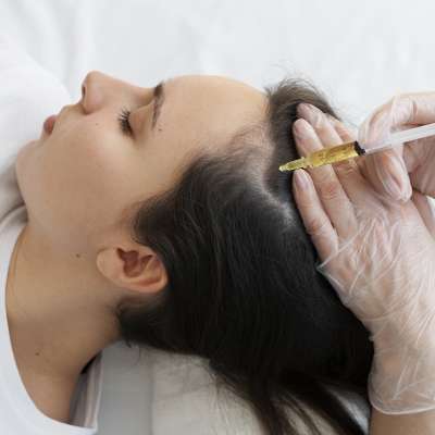 Doctor performing GFC hair treatment