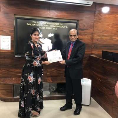 Dr. Sneha Kovi, the best cosmetologist in Guntur receiving her certification for training in Aesthetics