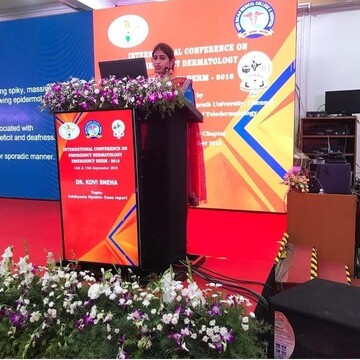Dr. Sneha Kovi, the best dermatologist in Guntur giving a speech at an international conference on dermatology