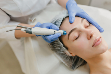 A woman undergoing hydrafacial treatment