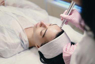 A woman undergoing microdermabrasion treatment
