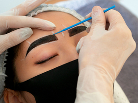 A woman undergoing semi permanent eye brow treatment